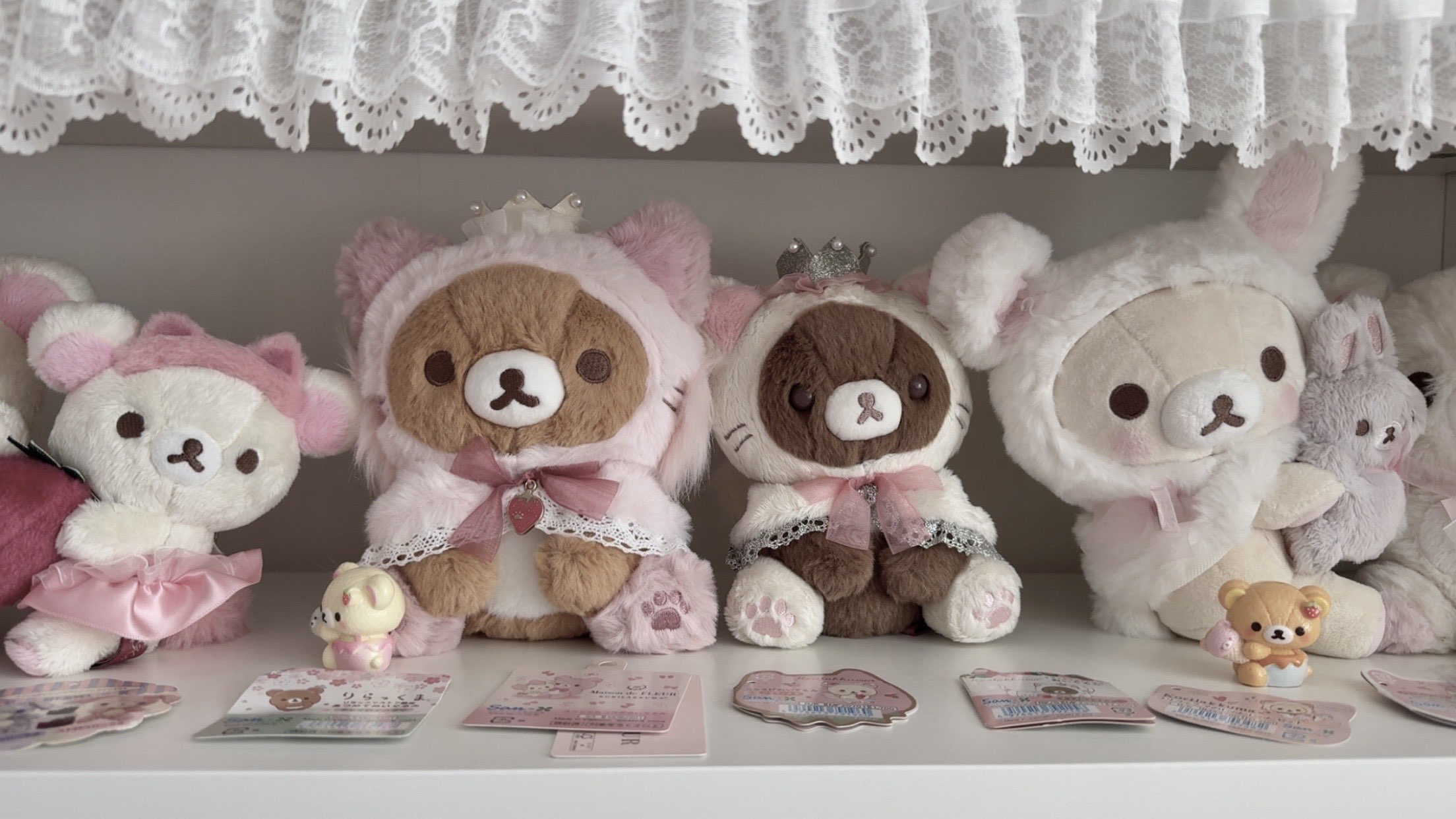 Close-up of plushies on a white shelf
